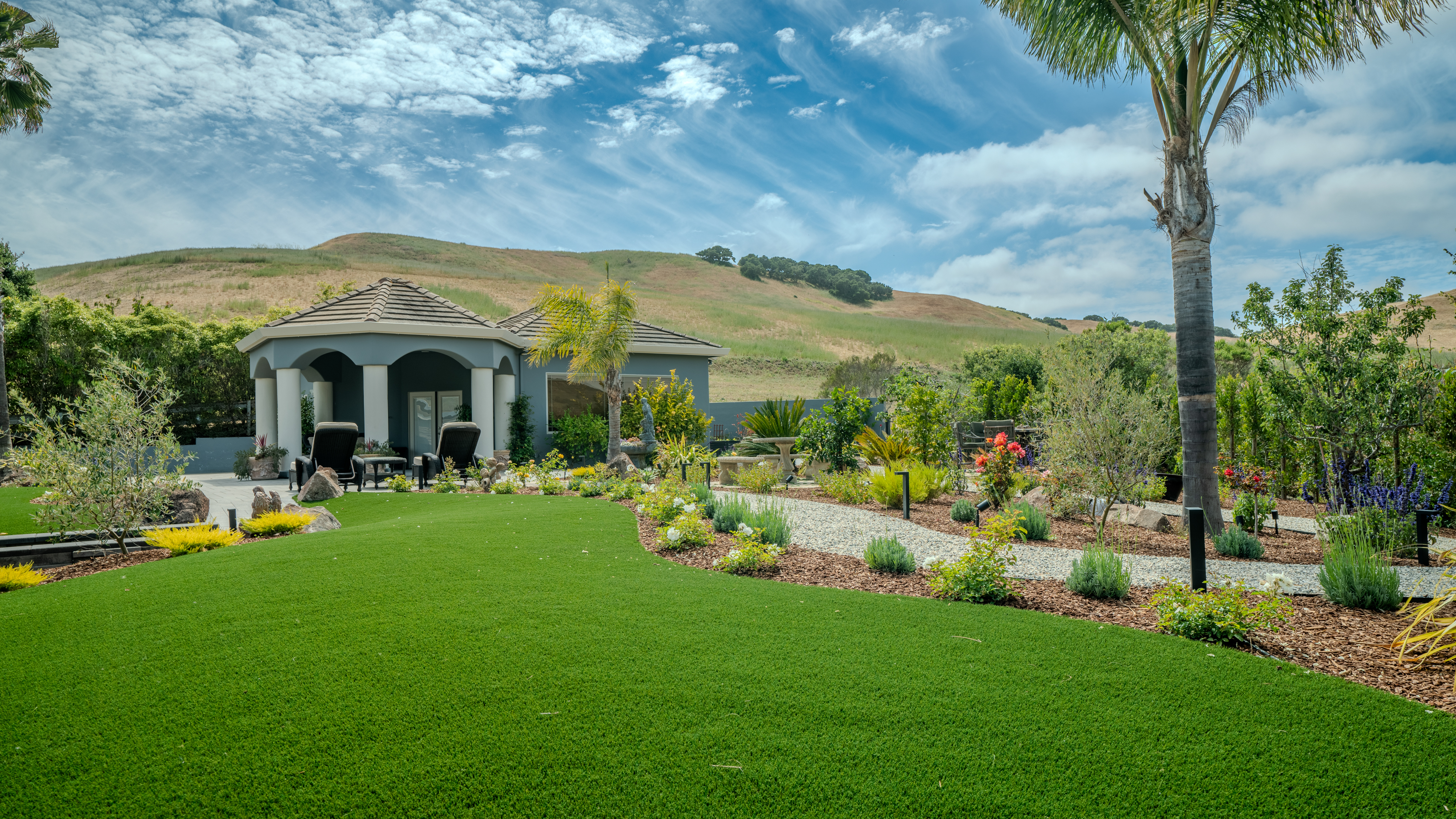 A completed PM Landscaping garden with lawn, planting and a pavilion